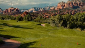 A golf course with a clear view of red rock formations in the background. - Red Rock Retreat • Golf • Hiking & Biking Trails • Views • Dining VOC •Adventure (Sedona)