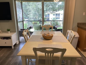 Enjoy meals with family and friends at this dining area, featuring a table for four and comfortable seating.
