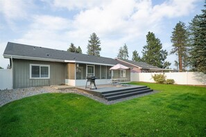 Private fenced backyard with deck, grill, and plenty of green space