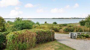 A pathway leading to a body of water with a grassy area and a small structure. - Amazing home in Broager with kitchen (Broager)