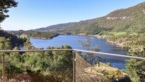A scenic view of a river surrounded by lush greenery and hills. - 4 bedroom stunning home in Hebnes (Hebnes)