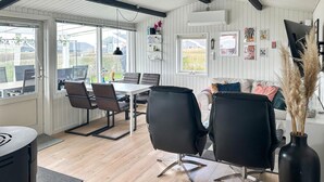 A modern interior with a dining area, black chairs, a white table, and a sofa. - Pet friendly home in Hejls with WiFi (Hejls)
