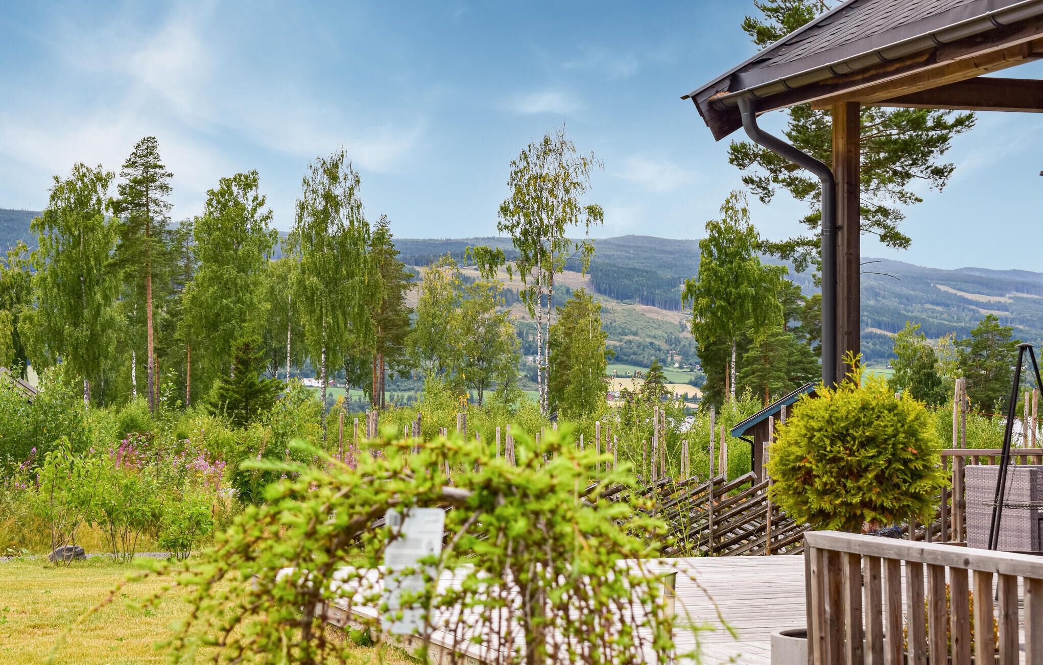A wooden deck with a view of a mountainous landscape.