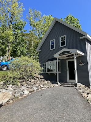 A two-story house with a covered porch and a garage.