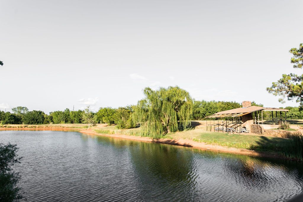 A serene lakeside setting with a rustic wooden structure near the water's edge.