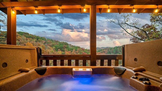 A hot tub with a view of a forested landscape. - Free Dollywood Tix/VIEWS/Secluded/Couples/HotTub/ (Sevierville)