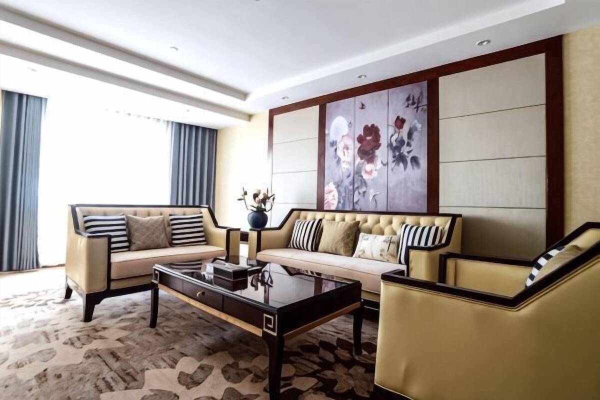 A modern living room with a sofa, armchair, and coffee table.