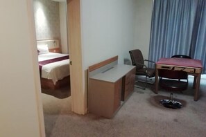 A hotel room with a bed, a desk, a chair, and a small table. - Lejia Hotel (Bazhou Shengfang International Furniture Expo City) (Bazhou)