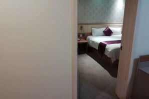 A hotel room with a bed, a nightstand, and a carpeted floor. - Lejia Hotel (Bazhou Shengfang International Furniture Expo City) (Bazhou)