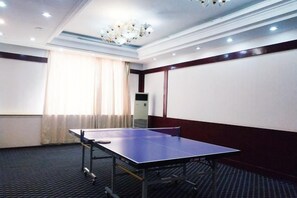 A conference room with a table and chairs, a projector, and a large screen. - Jinta Hotel (Jinta)