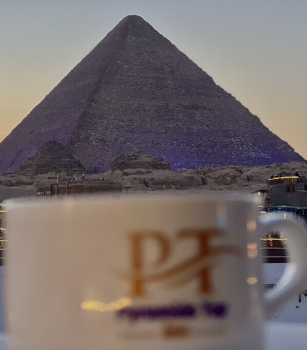 A pyramid with a cup in the foreground.