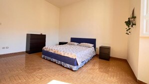 A bedroom with a bed, a dresser, a nightstand, and a small desk. - In the center of Porretta Terme (Porretta Terme)