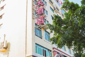 A multi-story building with a prominent sign indicating a hotel. - Jiangxia Hotel (Liuzhou)