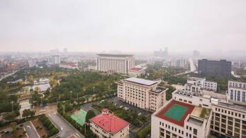 A cityscape with buildings, roads, and greenery.