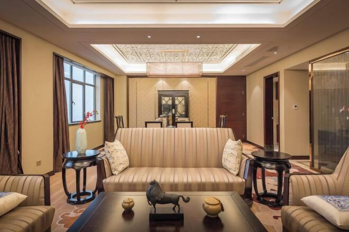 A well-lit living room with a sofa, two side tables, and decorative items.