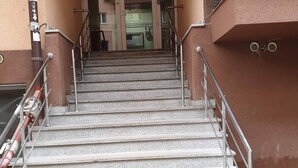 A set of concrete stairs leading to a building entrance with metal railings on both sides. - Impeccable 1-bed Studio in Roșu (Chiajna)