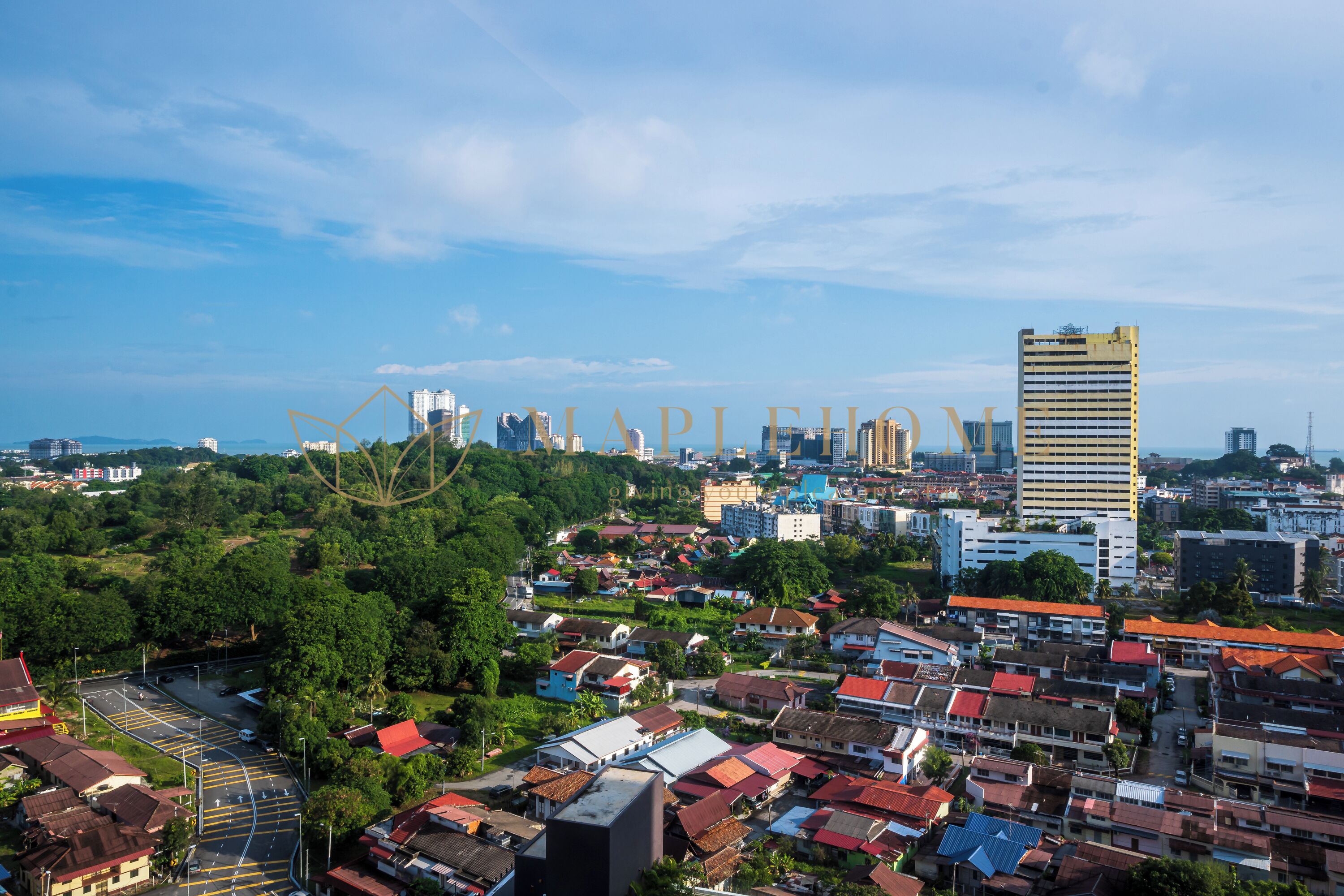 A cityscape with a prominent high-rise building, a mix of residential and commercial buildings, and a clear sky.