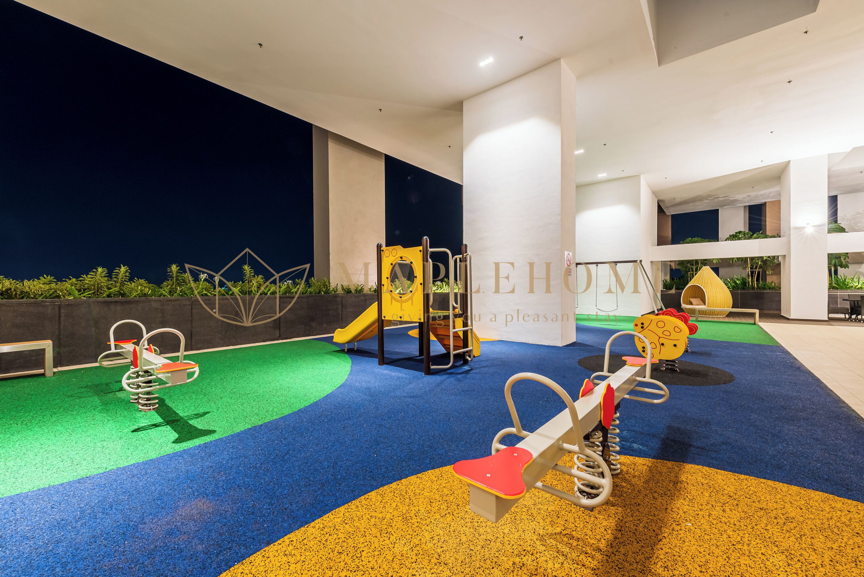 A children's play area with colorful flooring and various play equipment.