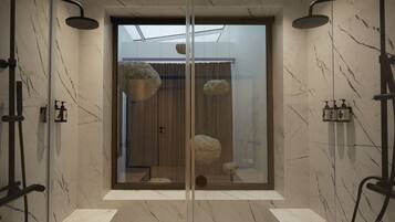 A modern bathroom with a glass enclosure, marble walls, and a skylight.