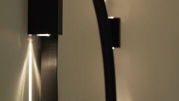 A wall-mounted light fixture with a sleek, modern design.