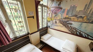 A hotel room with two single beds, a large window with a cityscape mural, and a view of the city. - National Inn HK (Kowloon)