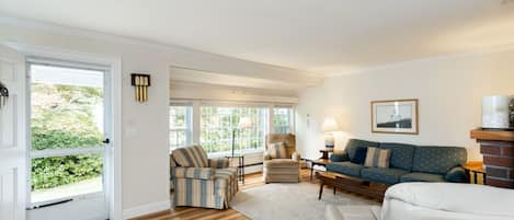 A living room with a sofa, armchair, and a coffee table.