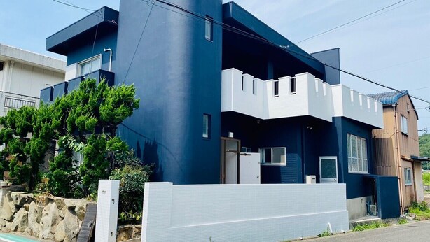 A modern two-story building with a flat roof and a large tree in front. - AZ Hotel Minamiawaji (Minamiawaji)