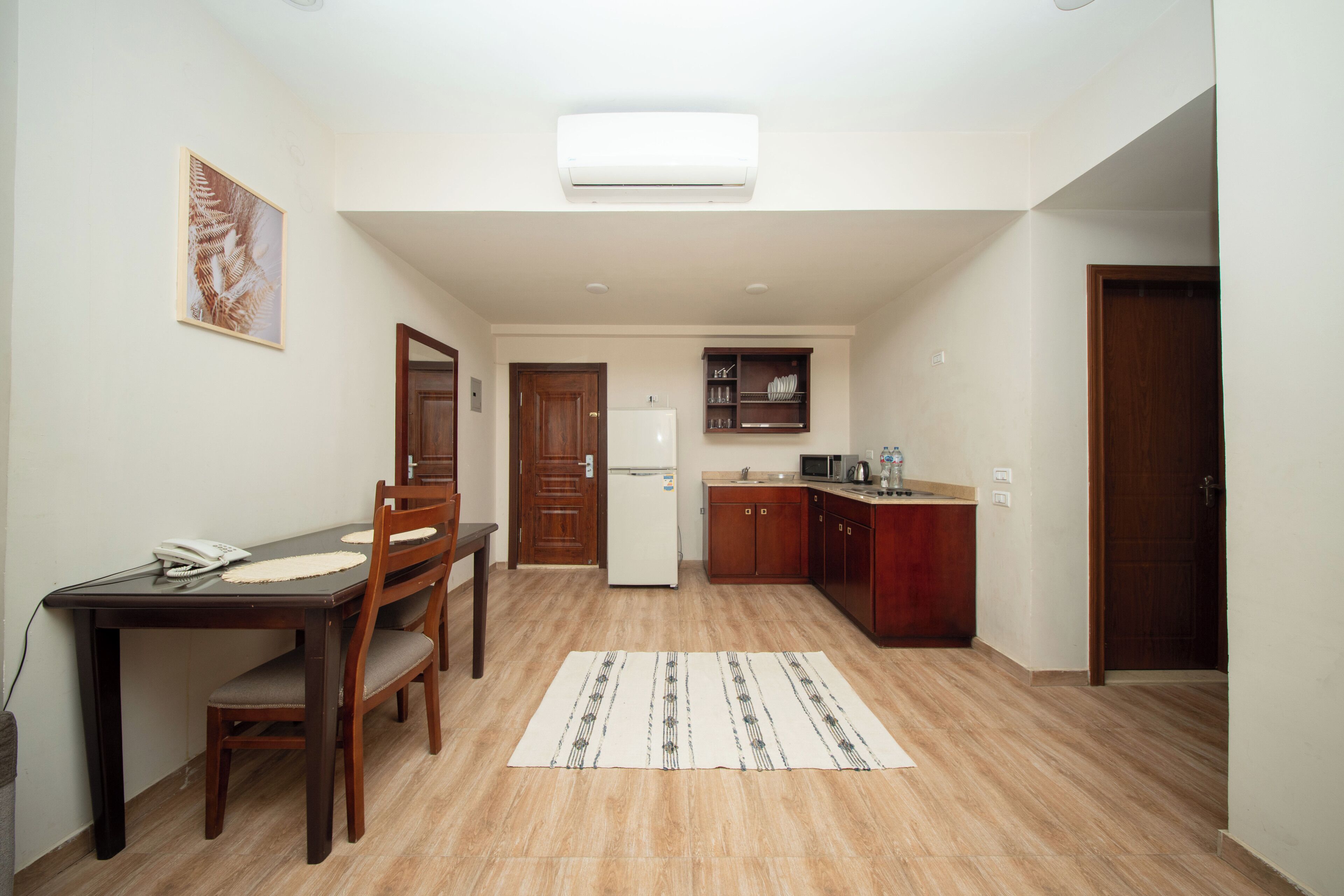Standard Apartment, Multiple Beds | Private kitchen | Coffee/tea maker, electric kettle, dining tables