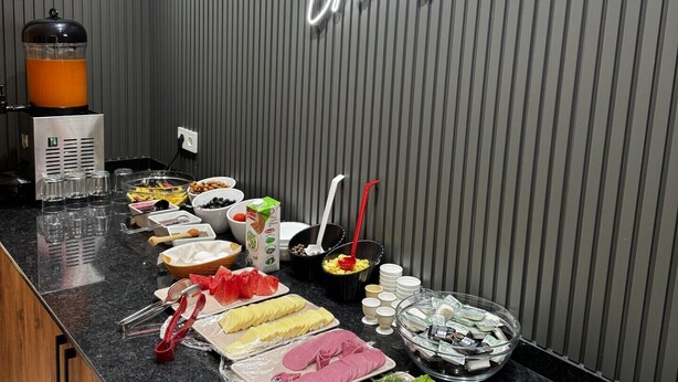 A breakfast buffet with various food items and a neon sign reading "elit otel Breakfast". - Elit Otel (Antalya)