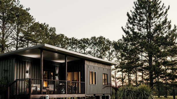 A modern cabin with a deck, surrounded by trees. - Contained in Nimbin (Nimbin)