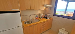 Fridge, microwave, stovetop, coffee/tea maker