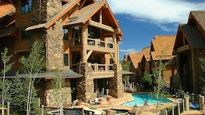 A resort with multiple buildings, a central pool, and outdoor seating areas. - Bearpaw D1 4 Bedroom Condo by RedAwning (Avon)