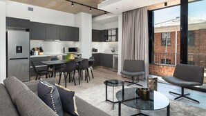 A modern apartment with a kitchen, dining area, and living room. - The Signature G07 (Cape Town)
