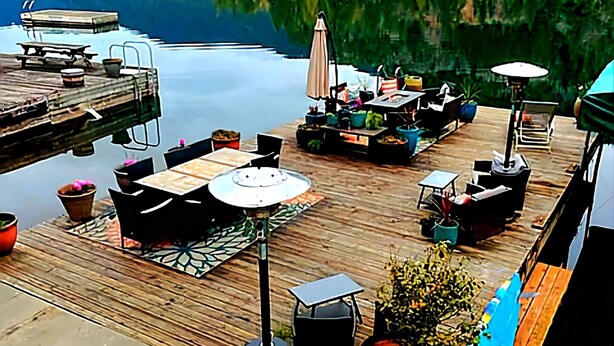 A wooden deck with outdoor seating, a hot tub, and a view of a lake and mountains. - Lakeside Living with HotTub, Kayaks, Paddleboard; close to Olympic National Park (Port Angeles)