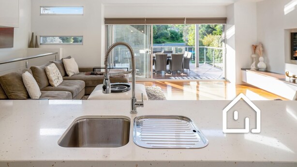 A modern kitchen with a large window, a built-in sink, and a dining area with a view of the outdoors. - The Cosmopolitan *1 NIGHT FREE* Stay in the Heart of Sorrento (Sorrento)