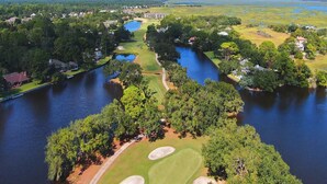 An aerial view of a golf course with water bodies, trees, and residential areas. - Sleeps 9! Serene Sea Palms Golf Condo on St Simons|Close to Beach, Restaurants!  (St. Simons Island)