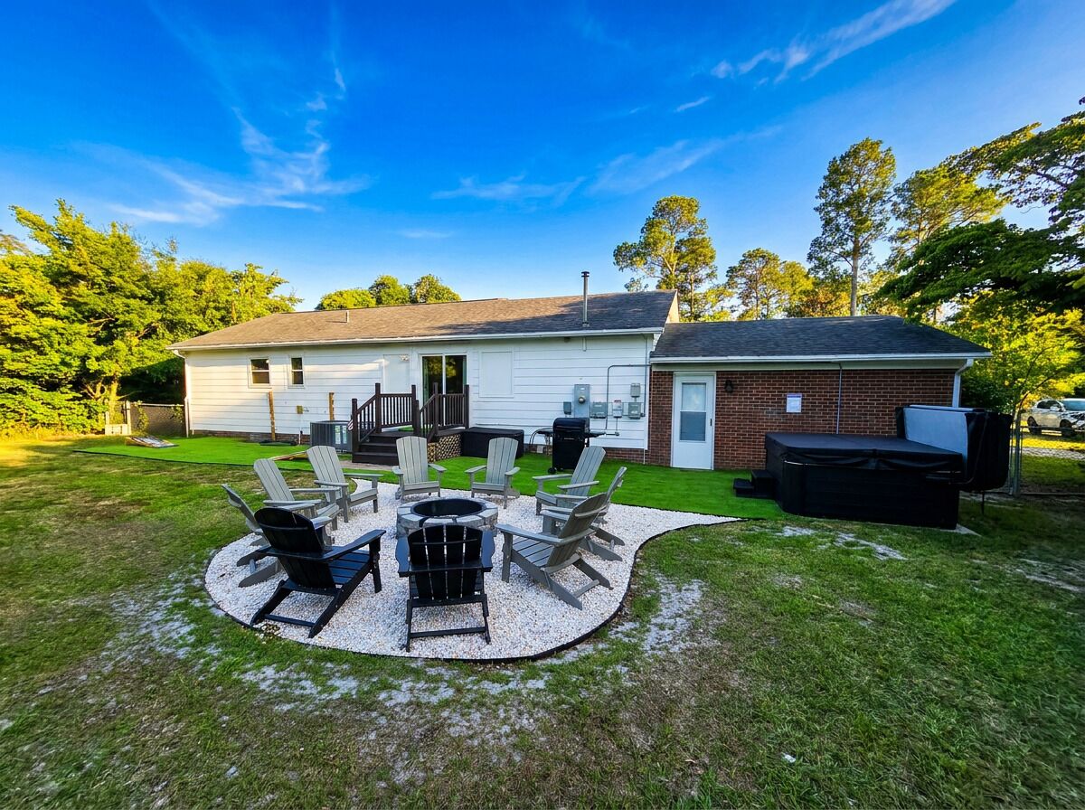 A house with a patio area featuring outdoor furniture and a grill.