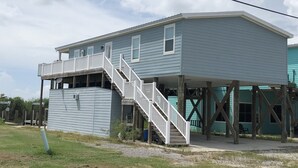 A two-story house with a balcony and a staircase leading to the upper floor.