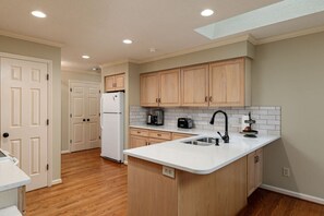 Fridge, microwave, coffee/tea maker, cookware/dishes/utensils