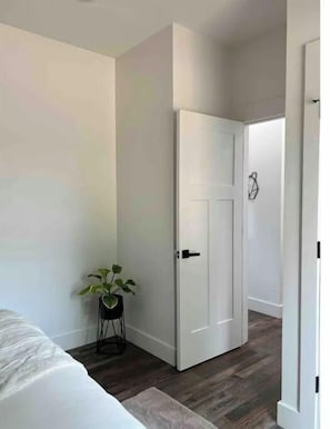 Relax in a serene space with a large bed, potted plant, and natural views.