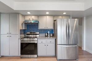 Enjoy cooking in this well-equipped kitchen with a double-door refrigerator and oven.