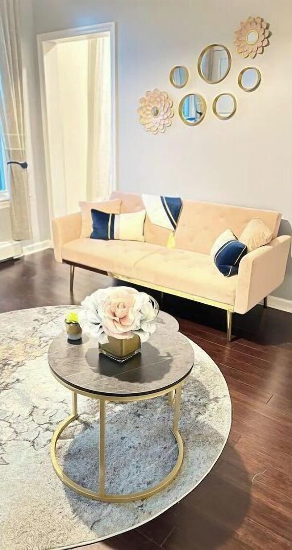Relax in this inviting living space with a comfortable sofa, coffee table, and beautiful floral arrangements.