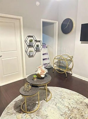 Enjoy dining and socializing in this stylish space with a round table, hexagonal shelf, and comfortable seating area.