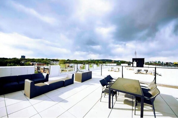 Relax on the rooftop with a sofa set and enjoy the city views from this urban retreat.