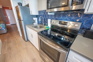 Enjoy cooking in this well-equipped kitchen with a stainless steel refrigerator, double oven, and microwave.