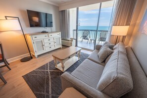Relax in a comfortable room with a sofa, flat-screen TV, and ocean view.