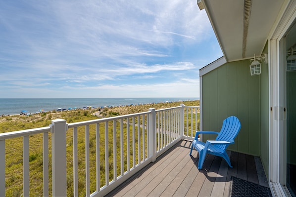 A wooden deck with a white railing overlooking a beach with umbrellas and lounge chairs. - 1A Bellevue St, Dewey Beach, DE OCEANFRONT-DOESN'T GET ANY BETTER THAN THIS! (Dewey Beach)