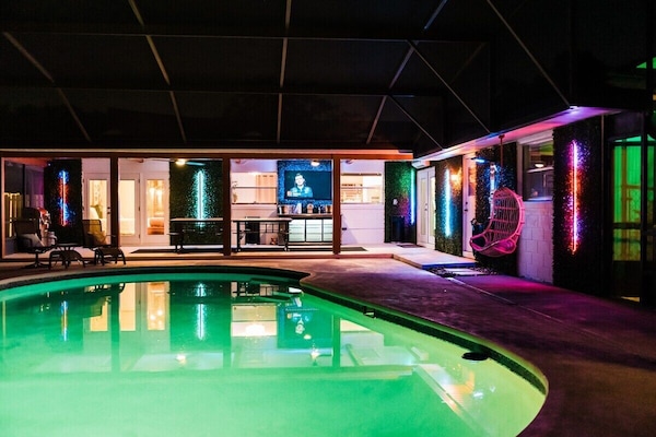 The pool transforms at night with stunning lights that set the perfect scene for unforgettable memories under the stars.