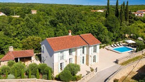 A large, two-story house with a swimming pool, surrounded by lush greenery and tall trees. - Villa LEMON BELLISSIMA (Ljutići)