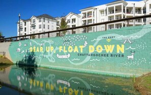 Experience the beauty of the Chattahoochee River with a vibrant mural featuring a canoe, deer, and waves.